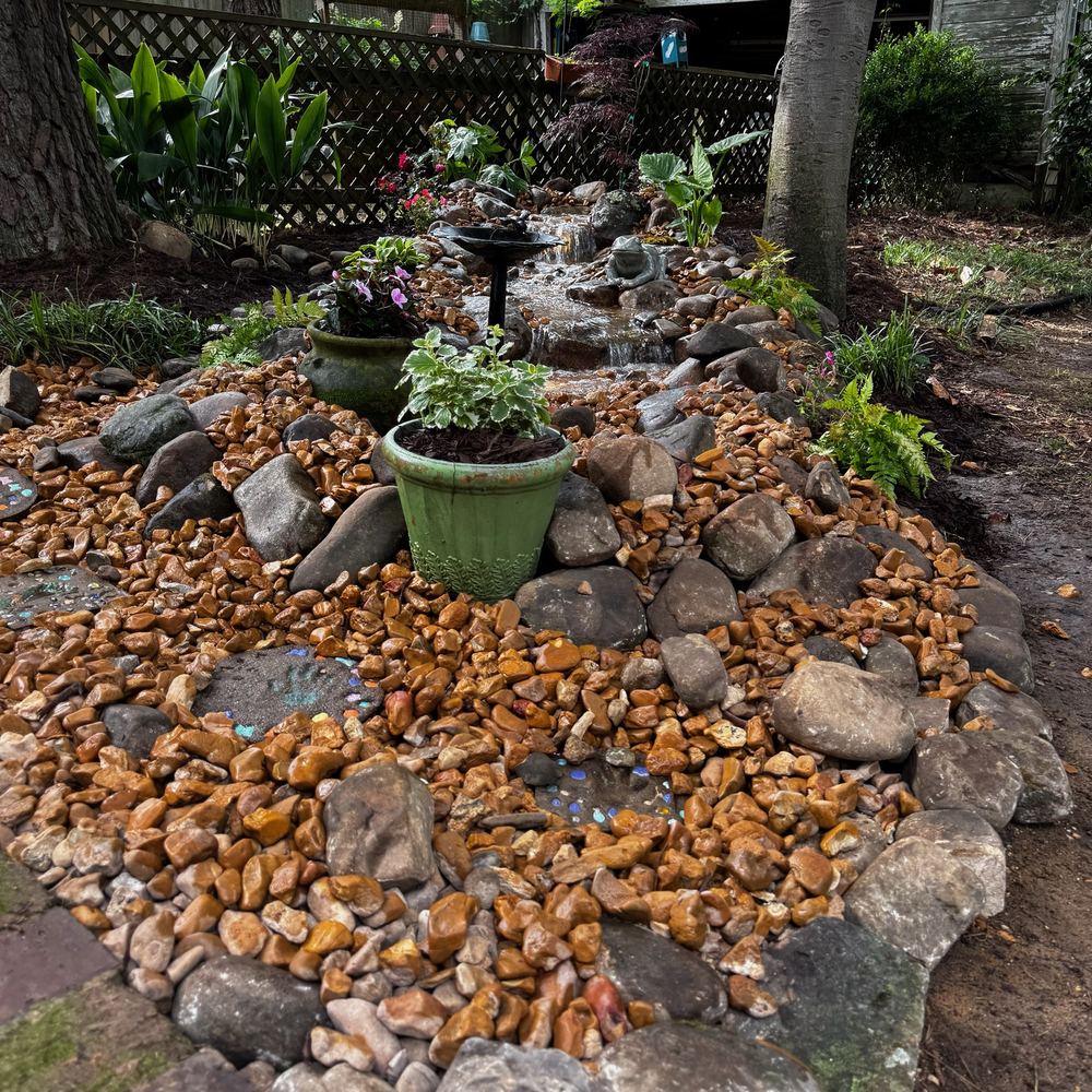 Superscapes rockscape with a dry-creek bed and fountain